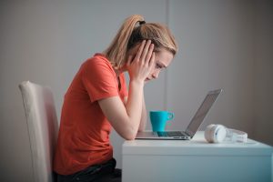 young troubled woman using laptop at home 3755755 scaled 1